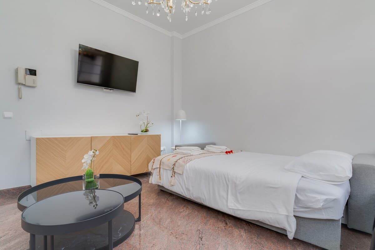 Living room with soft-bed and open kitchen