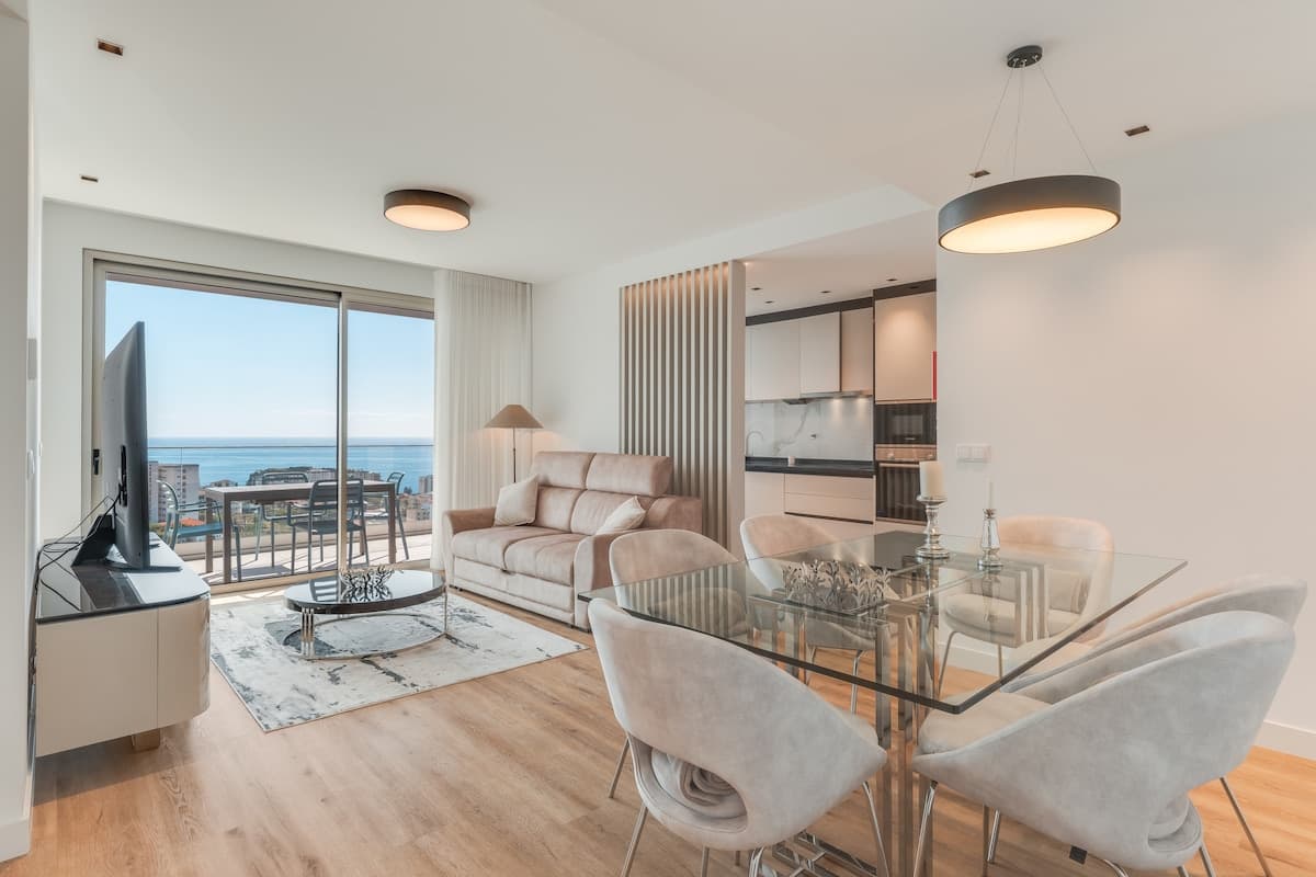 Spacious dining area featuring a large glass table that comfortably seats six — perfect for shared meals and memorable moments.