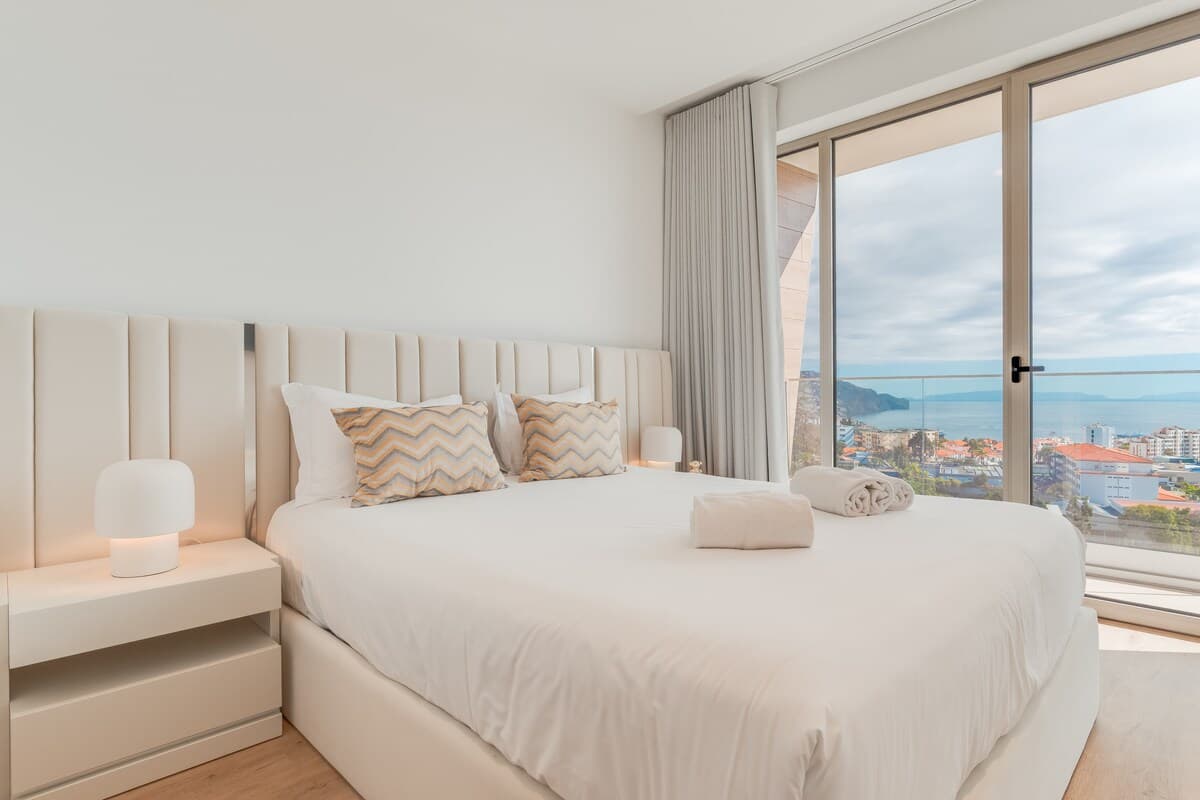 Relax in style and comfort in the elegant suite featuring a plush queen-size bed and soothing natural light — your private retreat for restful nights.
